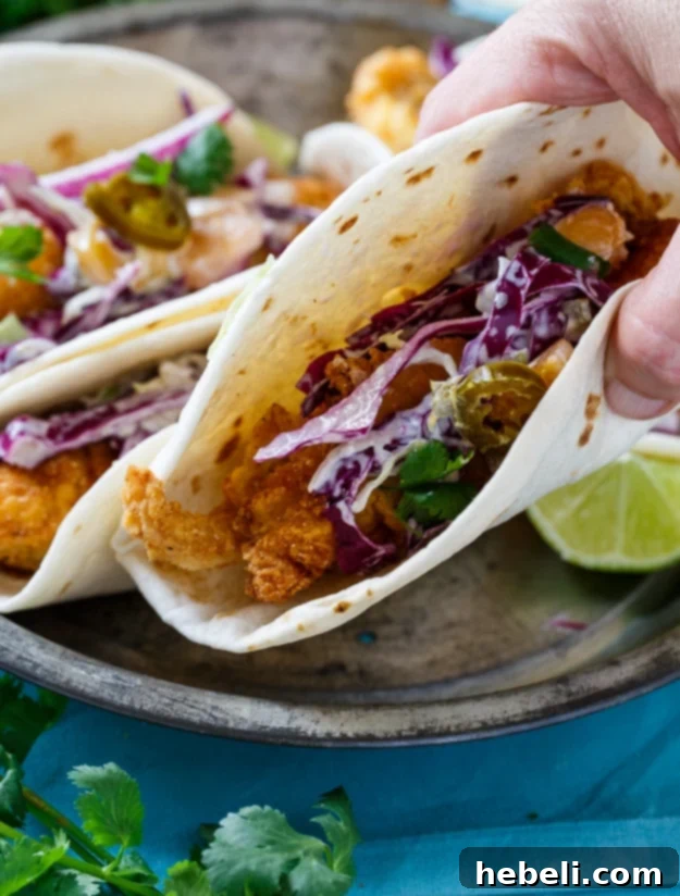 Southern Catfish Tacos with Jalapeno Peach Slaw, a close-up of the ingredients and a finished taco.