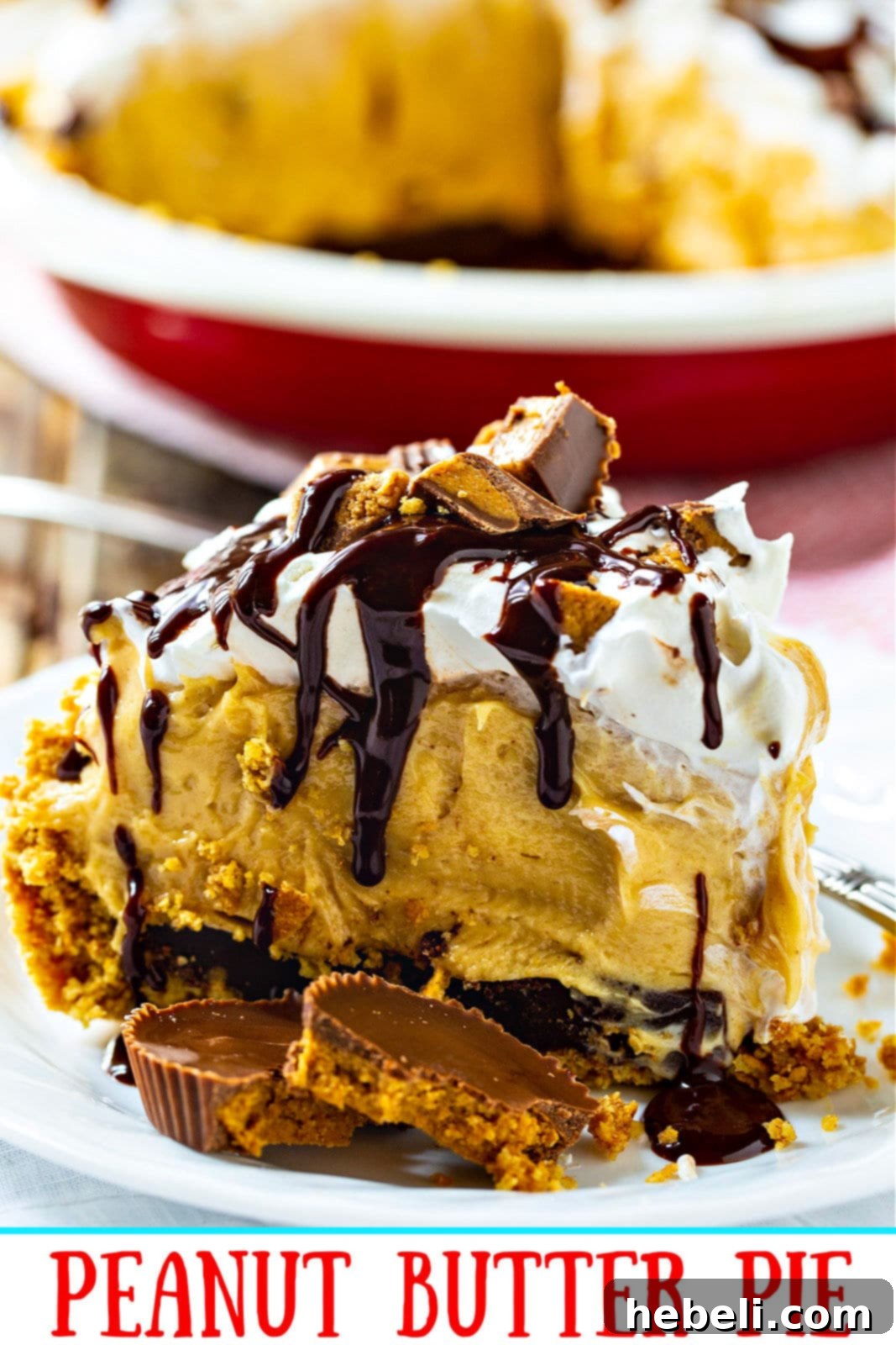 A single slice of Peanut Butter Pie, perfectly portioned and ready to be served, sitting on a clean white plate with a fork.