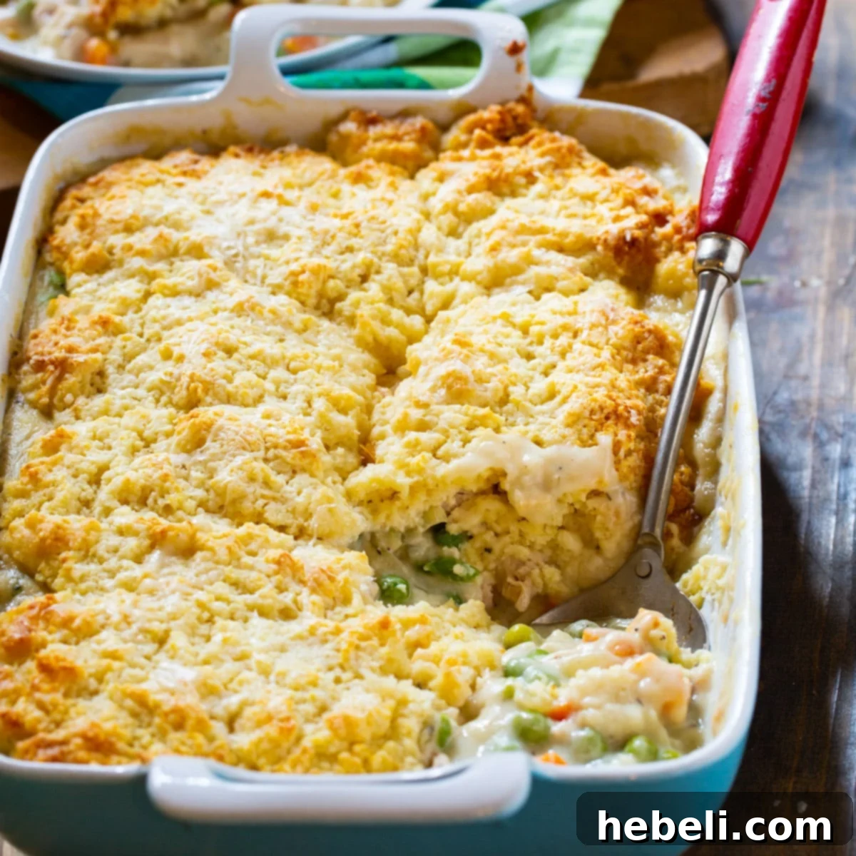 Golden-brown Chicken Pot Pie with Biscuit Topping in a ceramic baking dish, ready to serve.