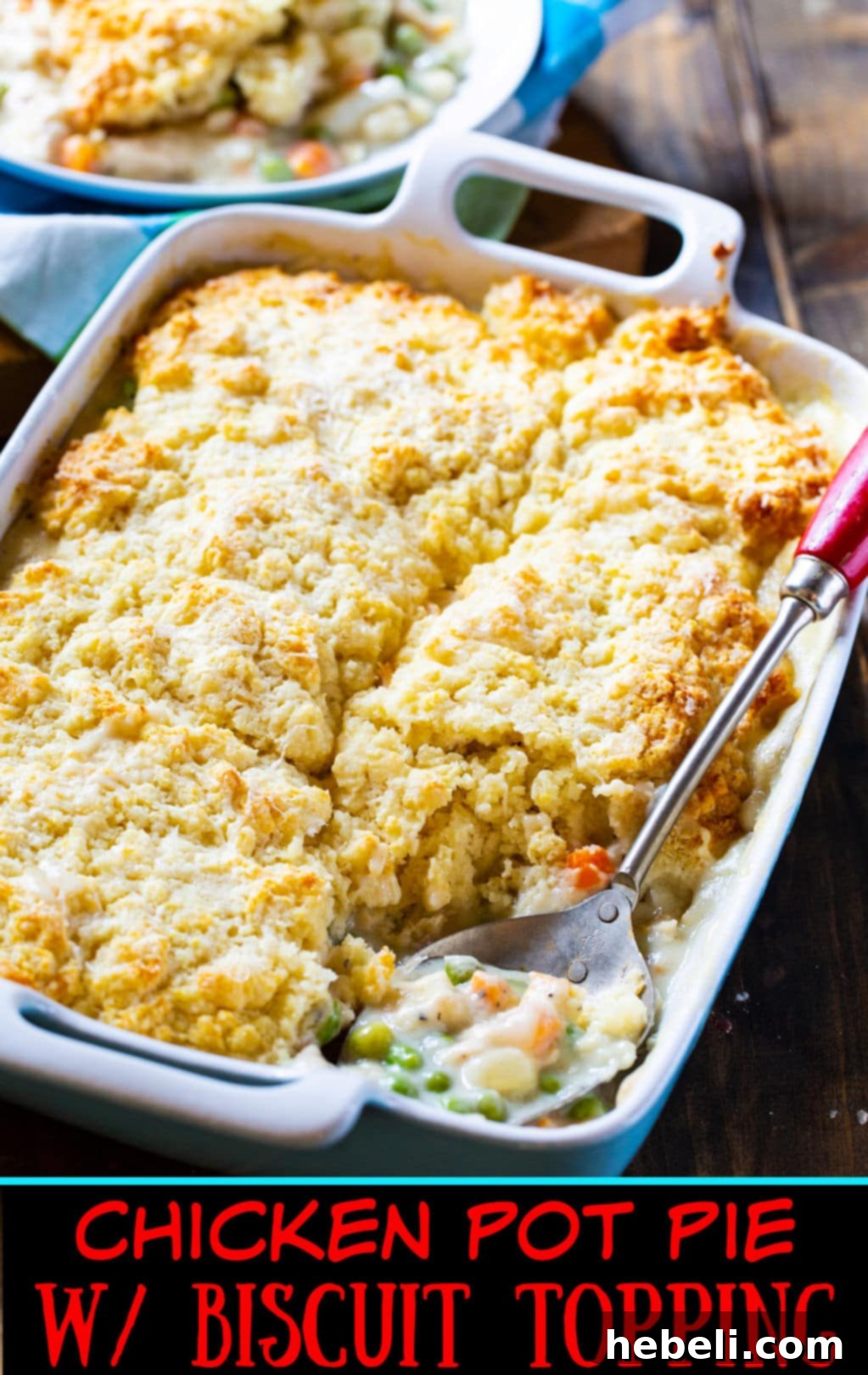 Overhead view of a cooked Chicken Pot Pie with golden biscuits, served with a sprig of fresh herbs.