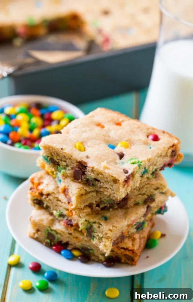 A square M&M Blondie with a bite taken out, revealing its soft interior