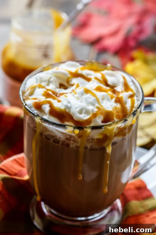 Caramel Sea Salt Latte 7 A perfectly frothed and beautifully layered Salted Caramel Latte in a clear glass mug, ready to be enjoyed as a luxurious treat.