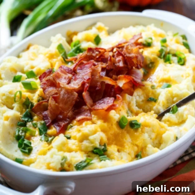 Loaded Mashed Potato Casserole with bacon and green onions, perfect for holidays.