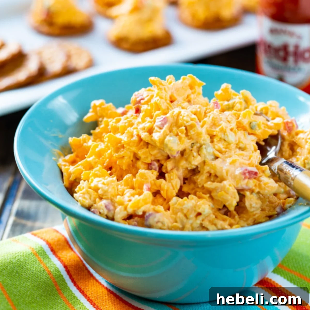 Kickin' Buffalo Pimento Spread 2 A vibrant blue bowl filled with creamy Buffalo Pimento Cheese, ready to be enjoyed.
