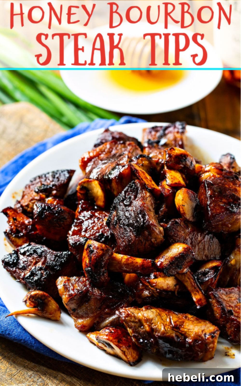 Honey Bourbon Steak Tips on a plate, garnished and ready to serve.