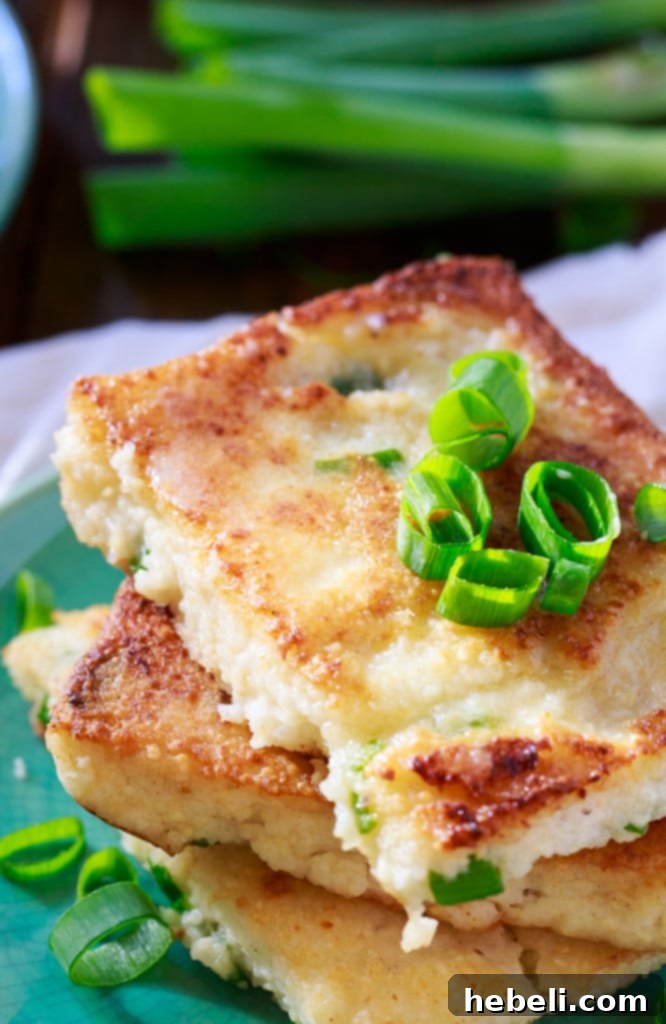 Creamy Mascarpone Grit Cakes 5 A plate of golden Mascarpone Grit Cakes with a side of sautéed shrimp and sausage