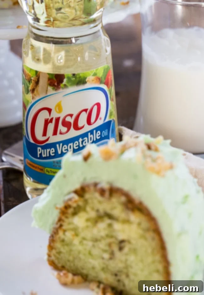 A close-up shot of the Watergate Cake, emphasizing its fluffy green frosting and moist texture, a perfect example of a vintage cake recipe made simple with modern ingredients.