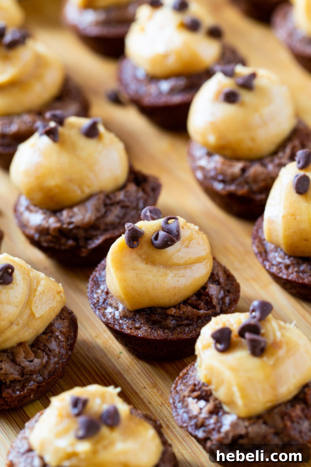 Decadent Peanut Butter Brownie Bites 4 Overhead shot of Peanut Butter Brownie Cups cooling on a wire rack, after being removed from the mini muffin tin, highlighting the indentations ready for filling.