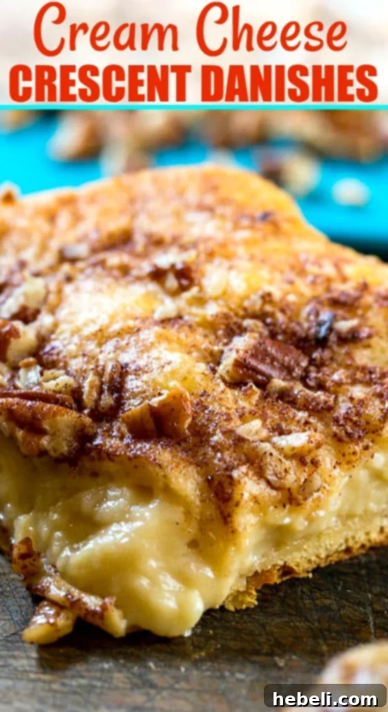 Close-up of a perfectly sliced Cream Cheese Crescent Danish, showing flaky layers and creamy filling.