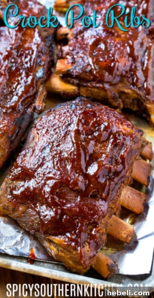 Close-up of perfectly glazed slow cooker ribs on a baking sheet, showcasing their rich color, crispy edges, and tender texture