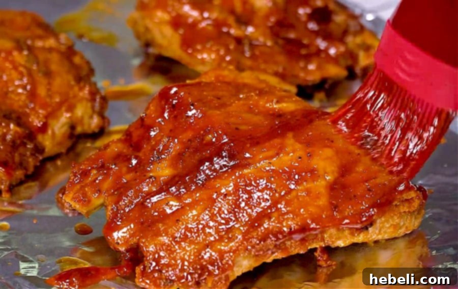Slow cooker ribs beautifully brushed with a thick glaze of BBQ sauce under the broiler for a caramelized and charred finish