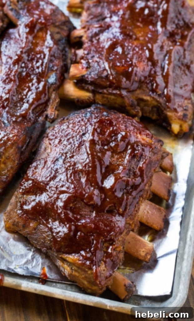Succulent, slow-cooked ribs, glazed and artfully arranged on a serving platter, showcasing their incredibly tender texture and rich color
