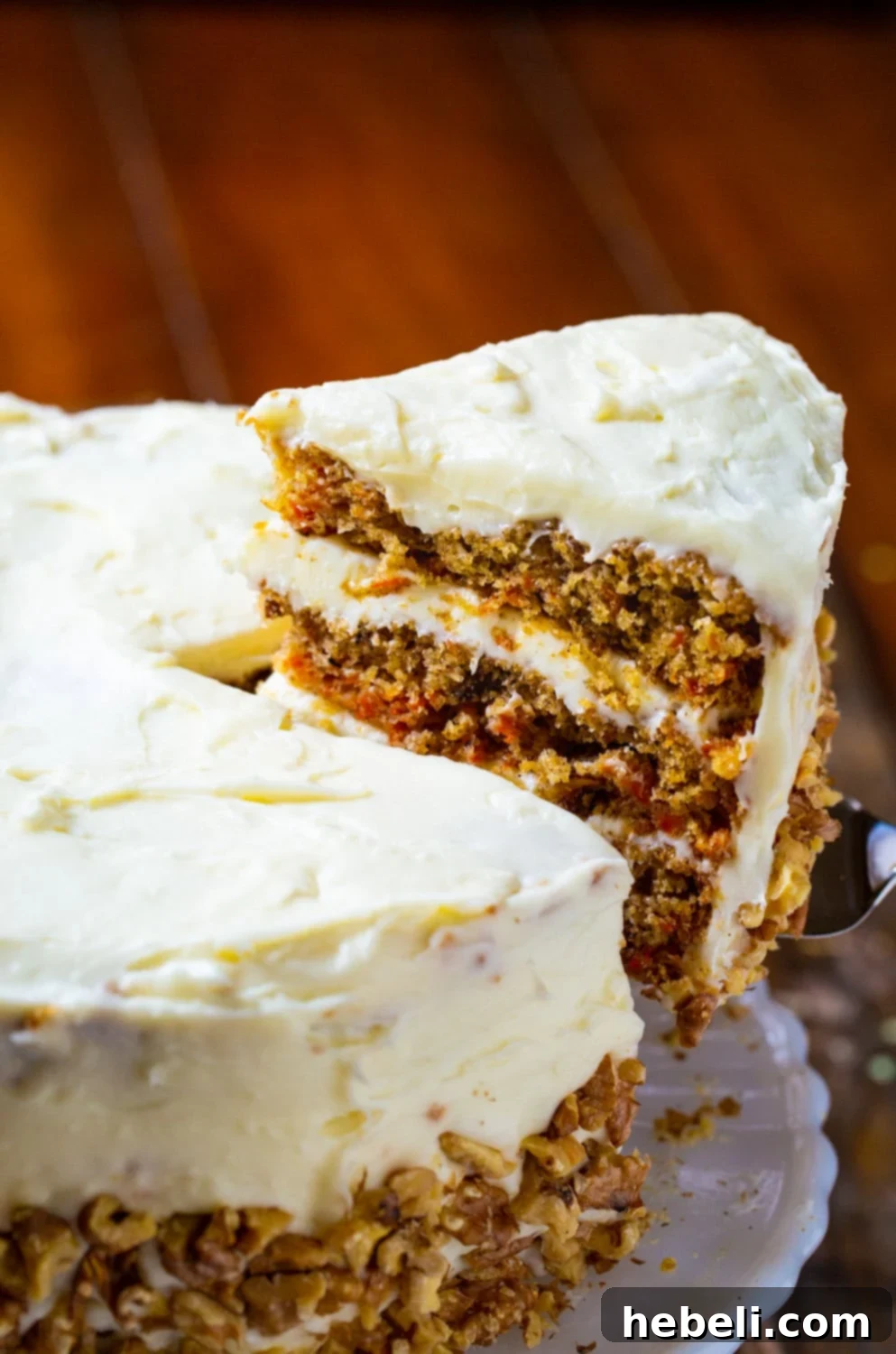 Mama Dip's Legendary Carrot Cake 3 A fresh slice of Carrot Cake being carefully removed from the main cake, ready to be served.