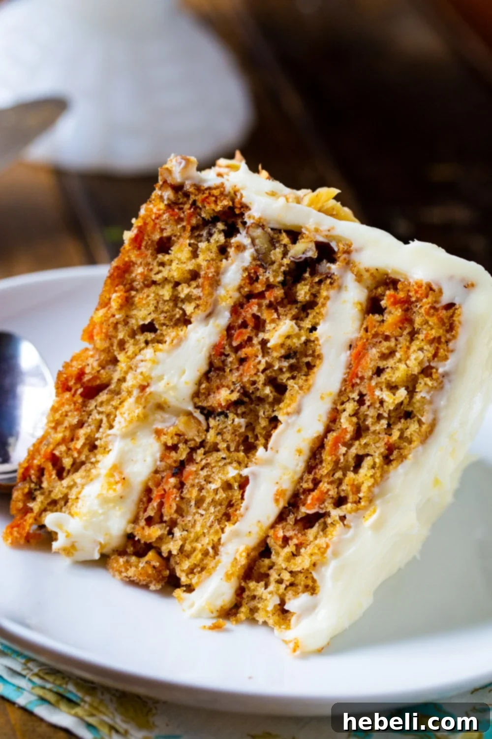 Mama Dip's Legendary Carrot Cake 5 A delicious slice of Carrot Cake served on a white plate, highlighting its rich layers and creamy frosting.