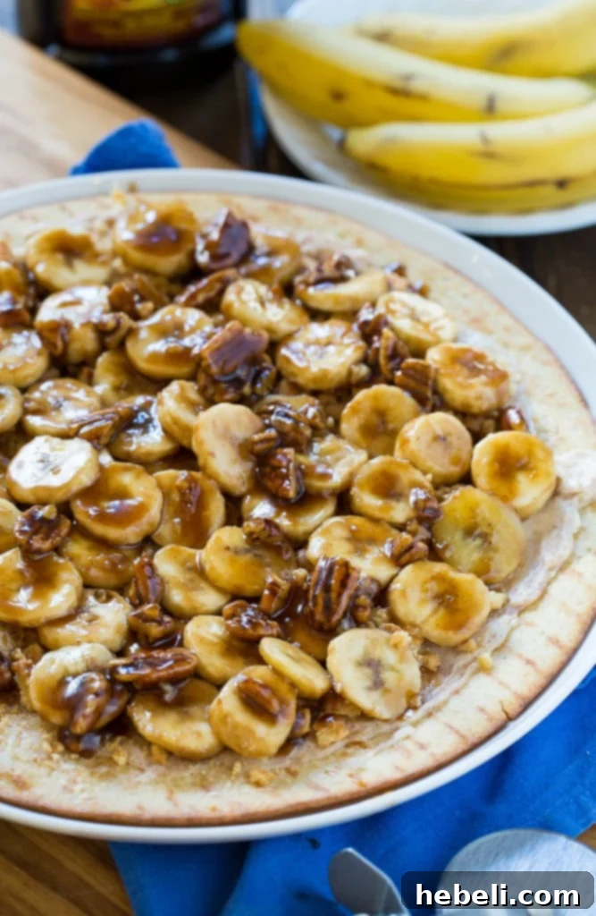 Close-up of Bananas Foster Dessert Pizza with caramel sauce and pecans