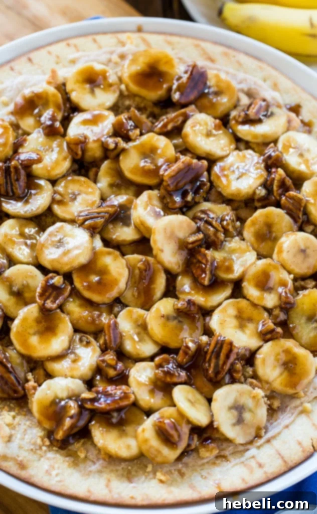 Bananas Foster Dessert Pizza on a rustic cutting board