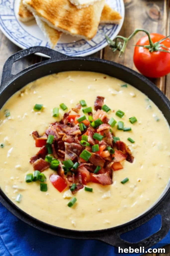 Molten Decadence Dip 3 Close-up of creamy Hot Brown Fondue with dippers, showcasing its rich texture.