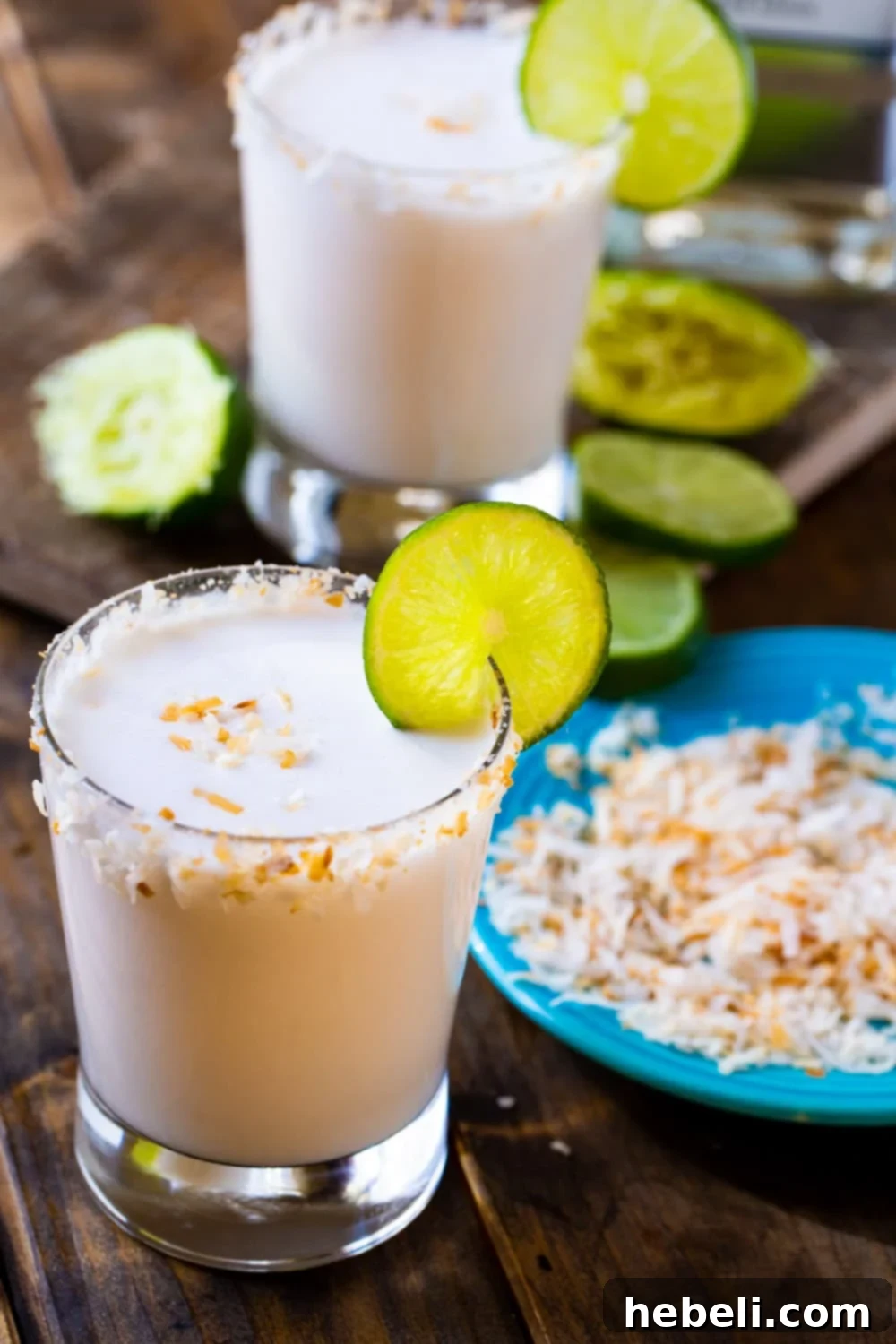 Two glasses of Coconut Margaritas, perfectly garnished, ready to be enjoyed.