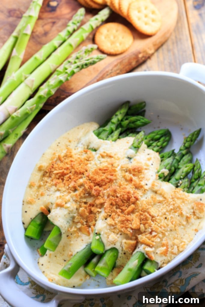 Asparagus Mornay - tender asparagus stalks covered in a cheesy sauce and crushed Ritz crackers. Perfect for Easter brunch.