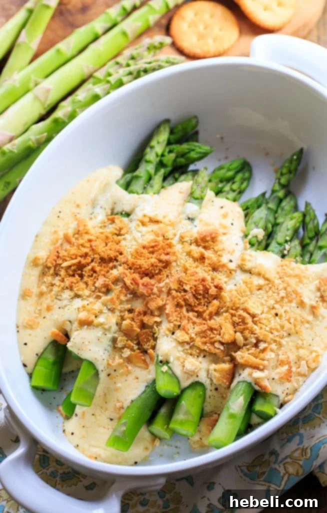 Asparagus Mornay - tender asparagus stalks covered in a cheesy sauce and crushed Ritz crackers. Perfect for Easter brunch.