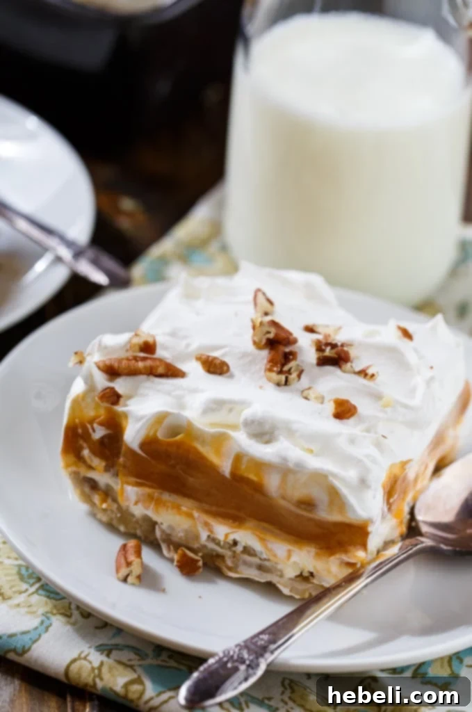 A beautifully layered Butterscotch Lush dessert in a baking dish, ready for chilling.