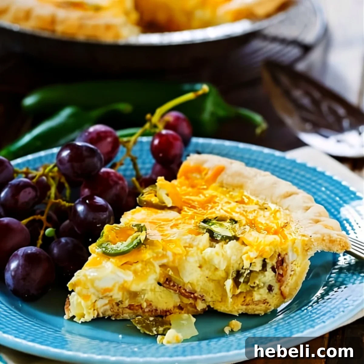 Spicy Cheesy Jalapeño Quiche 2 Slice of Jalapeno Popper Quiche on plate with red grapes.