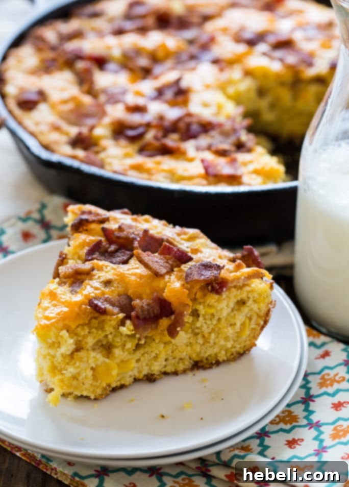 A hearty portion of Bacon Cheddar Cornbread served with a side of BBQ brisket and collard greens.