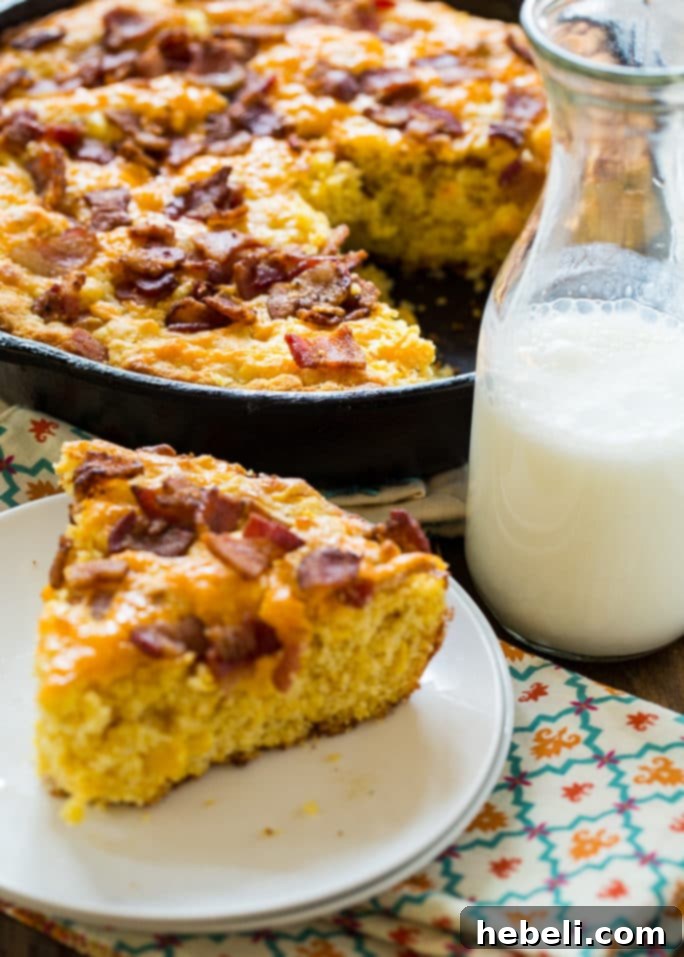 Multiple slices of Bacon Cheddar Cornbread stacked, ready for serving or storage.