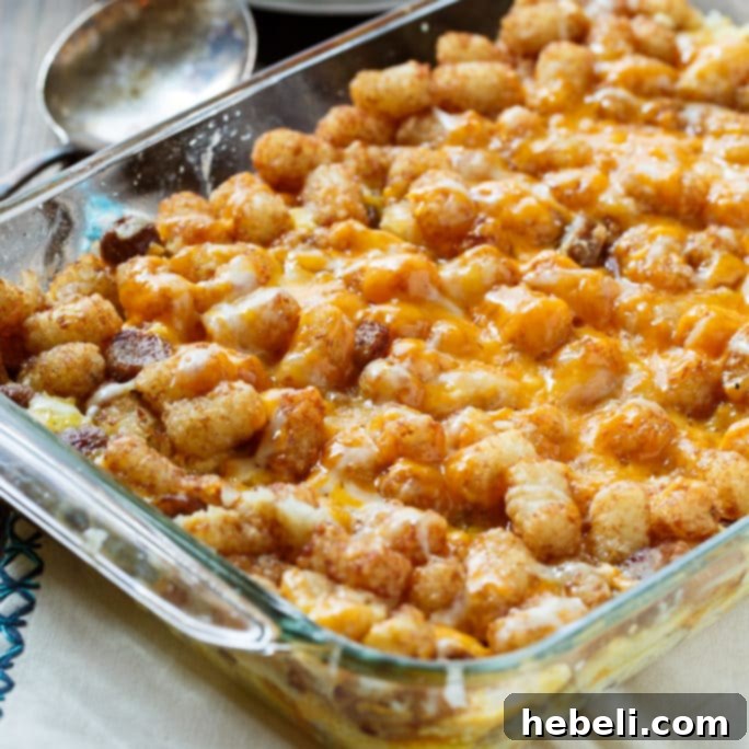 Hearty Breakfast Tater Tot Casserole with golden-brown tater tots, savory sausage, and melted cheddar cheese.