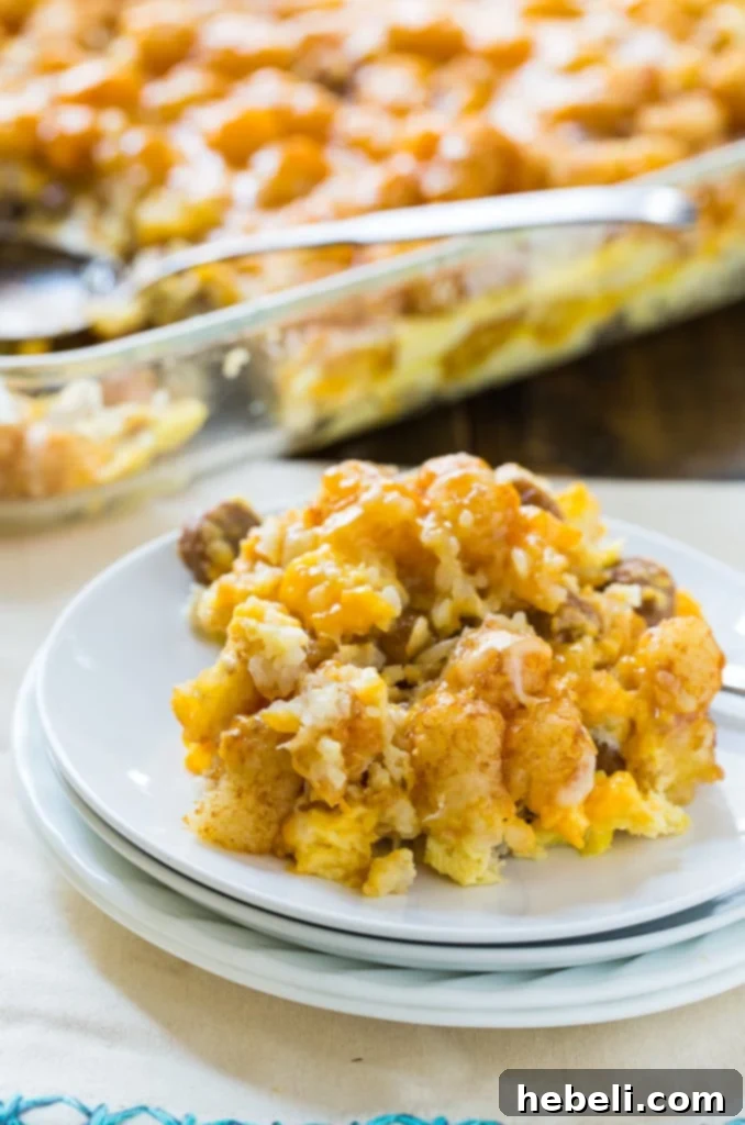 Sliced Breakfast Tater Tot Casserole in a serving dish, showing all the hearty ingredients.
