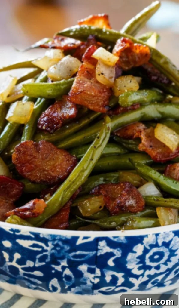 A close-up of a serving of Sweet and Sour Green Beans, showcasing the vibrant green color and savory additions.