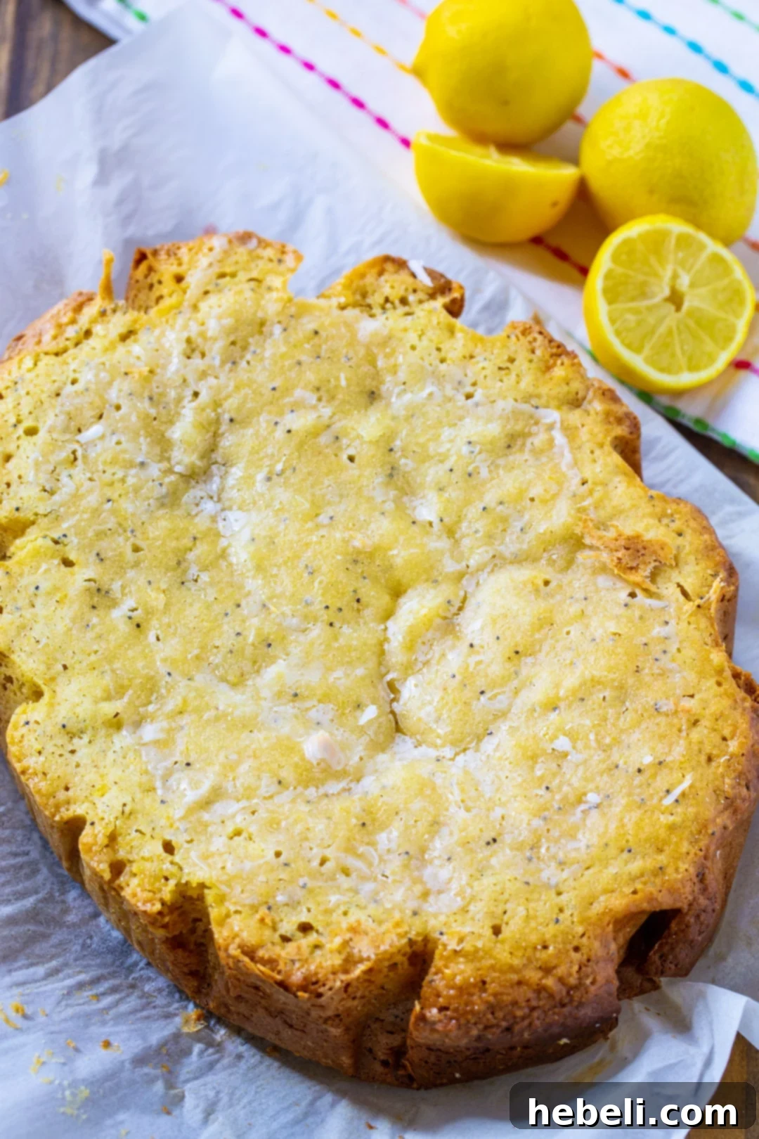 Crock-Pot Lemon Cloud Cake 4 A whole Slow Cooker Lemon Cake, beautifully glazed and presented with fresh lemons and a sprig of mint, ready to be served.