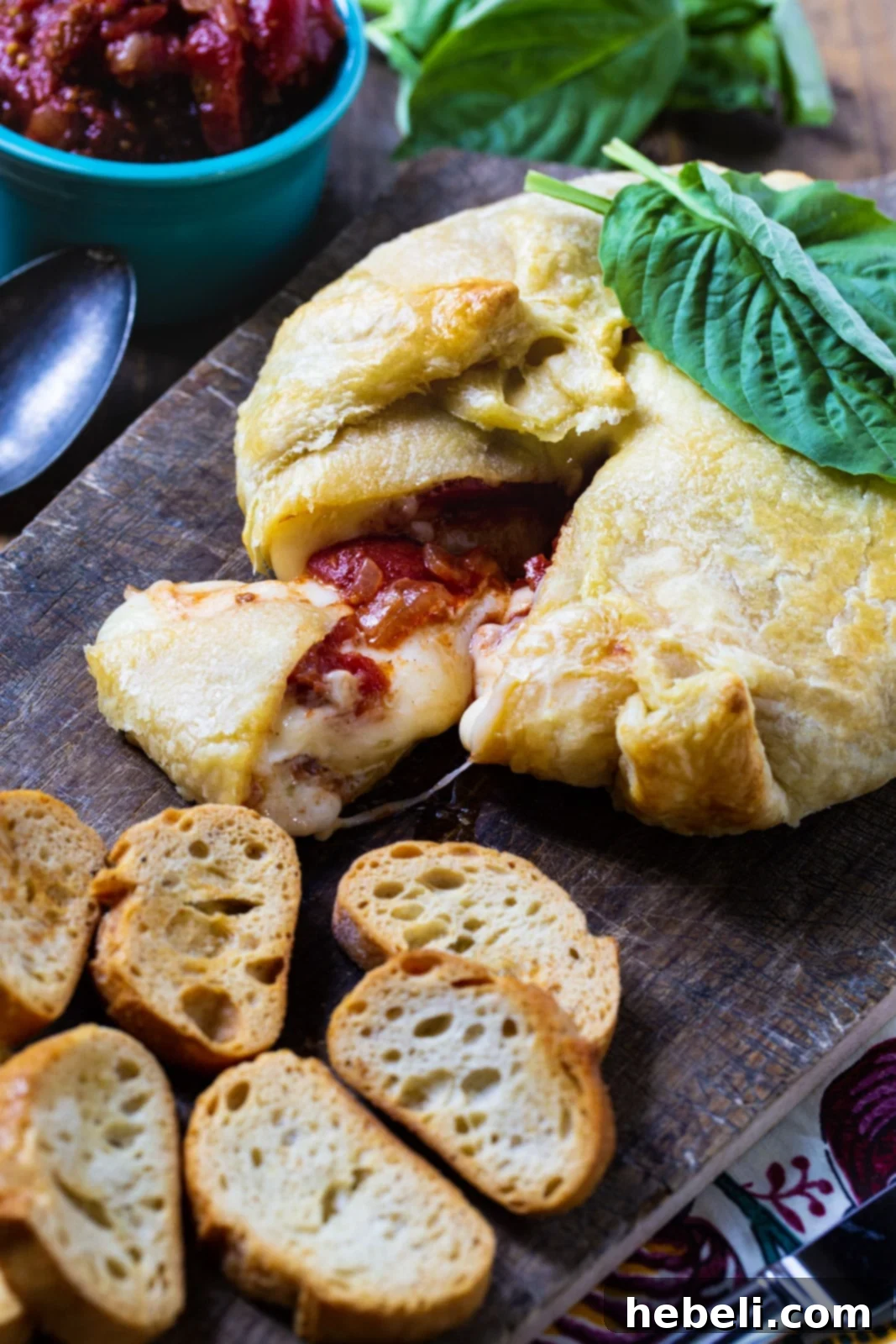 Golden Brie Bake with Tangy Tomato Chutney 5 Wrapped Brie with Tomato Chutney with baquette slices.