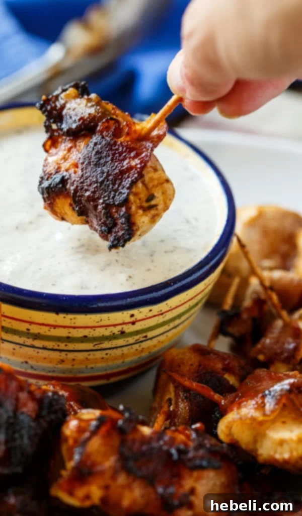 Smoky BBQ Bacon Chicken Poppers 6 A bottle of Stubb's BBQ Sauce next to grilled chicken bites.