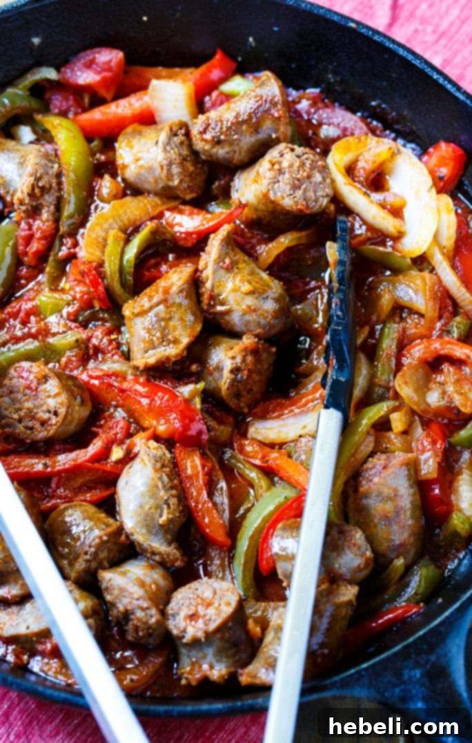 Close-up of freshly cooked Italian Sausage and Peppers with herbs