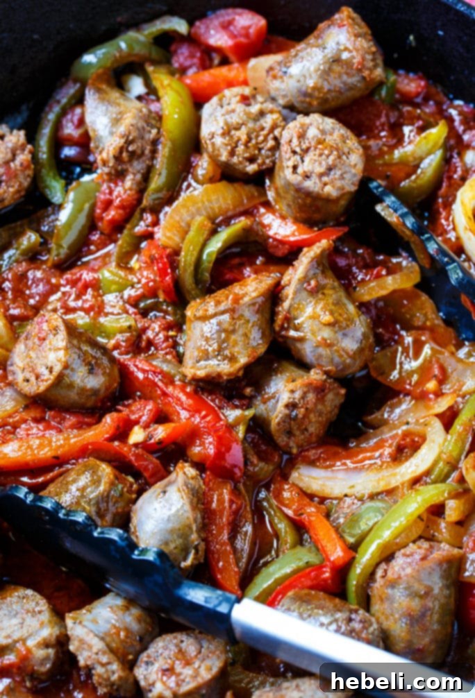 Italian Sausage and Peppers simmering in a pan