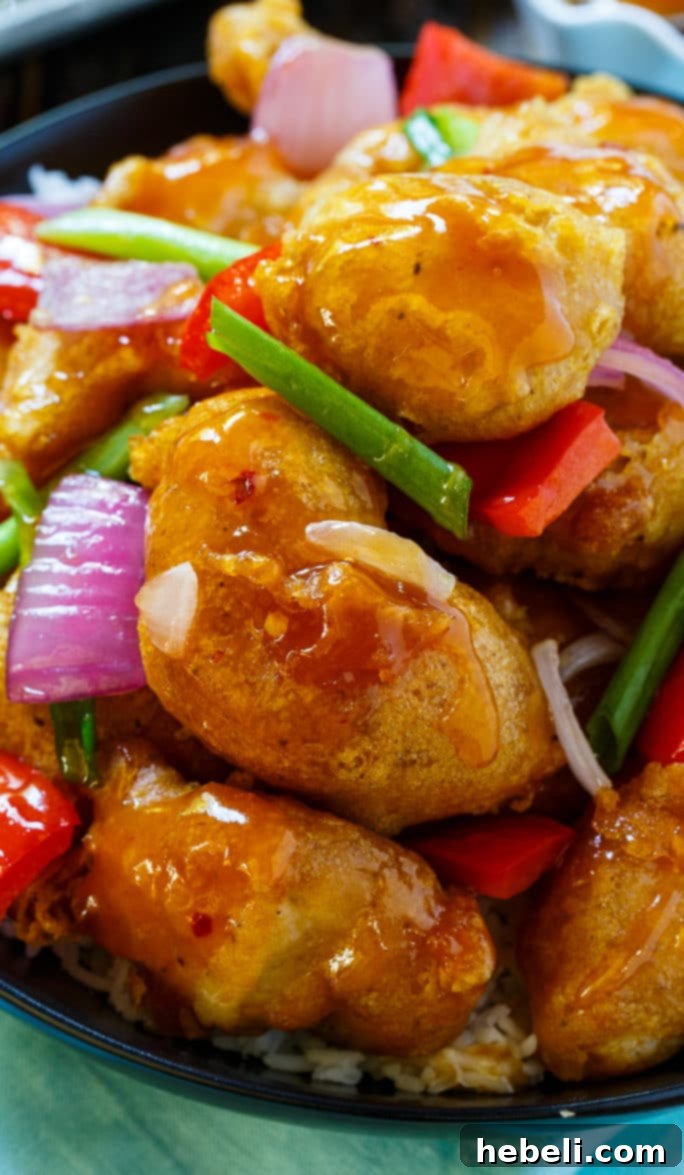 Ingredients for the sweet and sour sauce laid out, including pineapple juice, orange juice, ketchup, and vinegar.