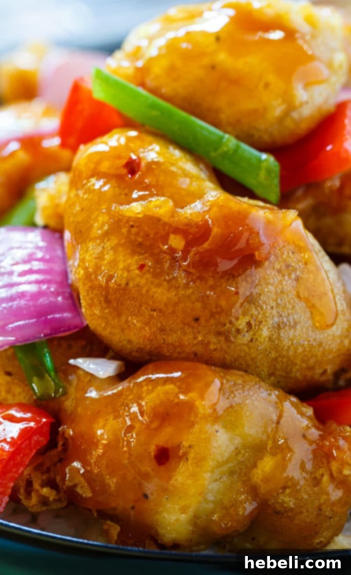 A vibrant bowl of homemade Sweet and Sour Chicken with vegetables, emphasizing its appeal and homemade quality.