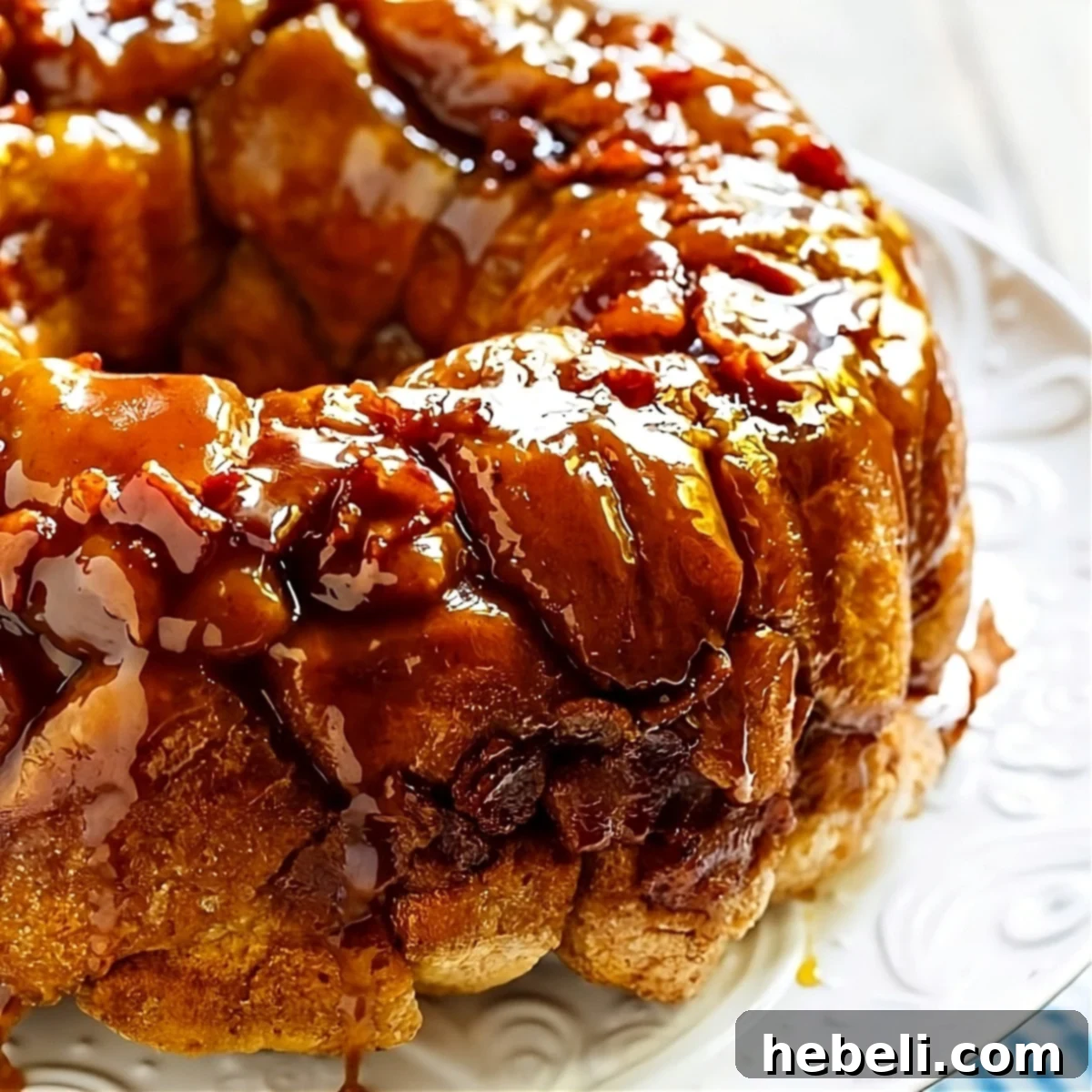Bacon Maple Monkey Bread on a serving platter, showcasing its gooey texture and bacon pieces.