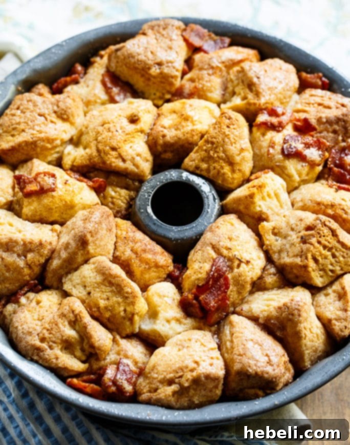 Pieces of biscuit dough being prepared for Bacon Maple Monkey Bread.