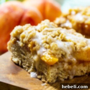 Easy and Delicious Peach Cobbler Bars 6 Peach Cobbler Bars with fresh peaches in background.