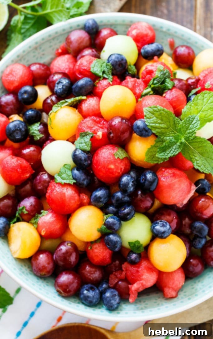 Mojito Fruit Salad featuring juicy fruits, fresh mint, and zesty lime.