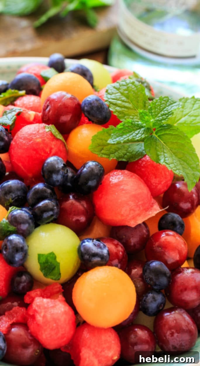 Closeup of Mojito Fruit Salad, showcasing the refreshing combination of fruit, mint, and lime.