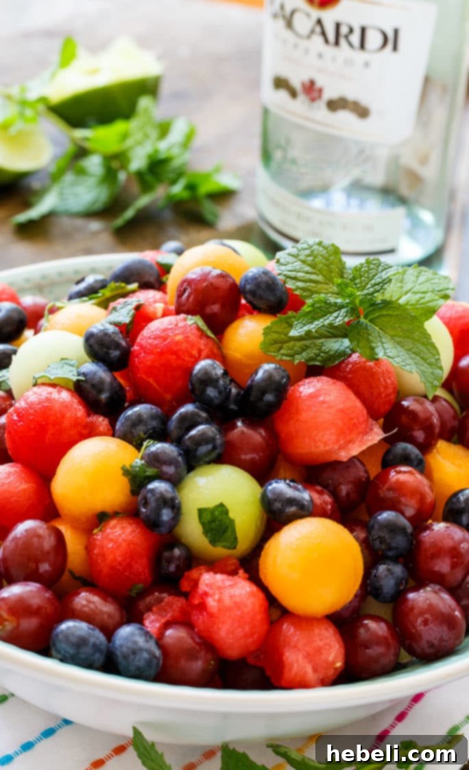 A bowl of super cold and refreshing Mojito Fruit Salad, perfect for summer.