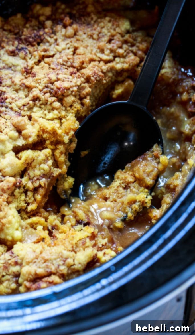 Warm & Cozy Slow Cooker Apple Cobbler 6 Slow Cooker Apple Cobbler bubbling and golden
