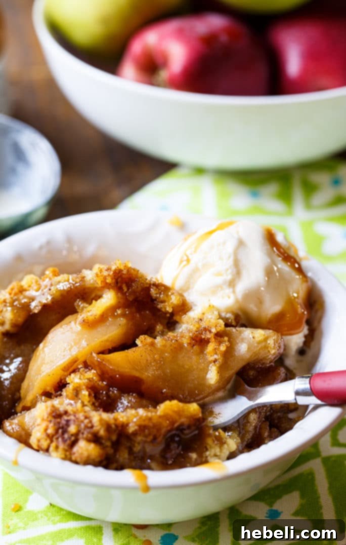 Warm & Cozy Slow Cooker Apple Cobbler 7 Slow Cooker Apple Cobbler served with melting vanilla ice cream