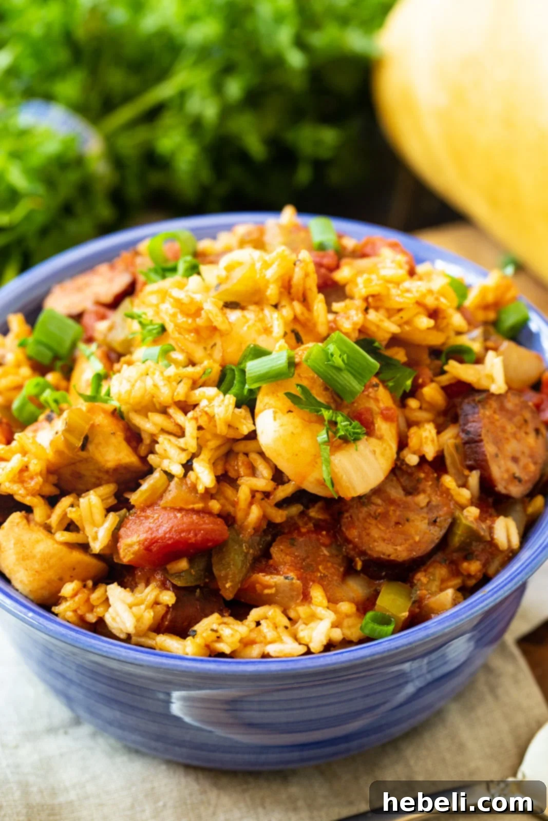 Set-and-Forget Slow Cooker Jambalaya 4 Slow Cooker Jambalaya served in a rustic blue bowl, ready to be enjoyed.