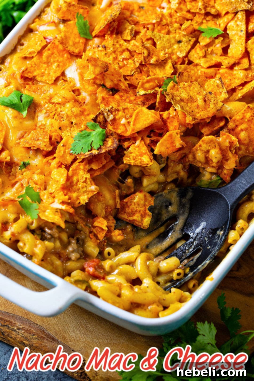 A delicious serving of Nacho Mac and Cheese with a spoon.