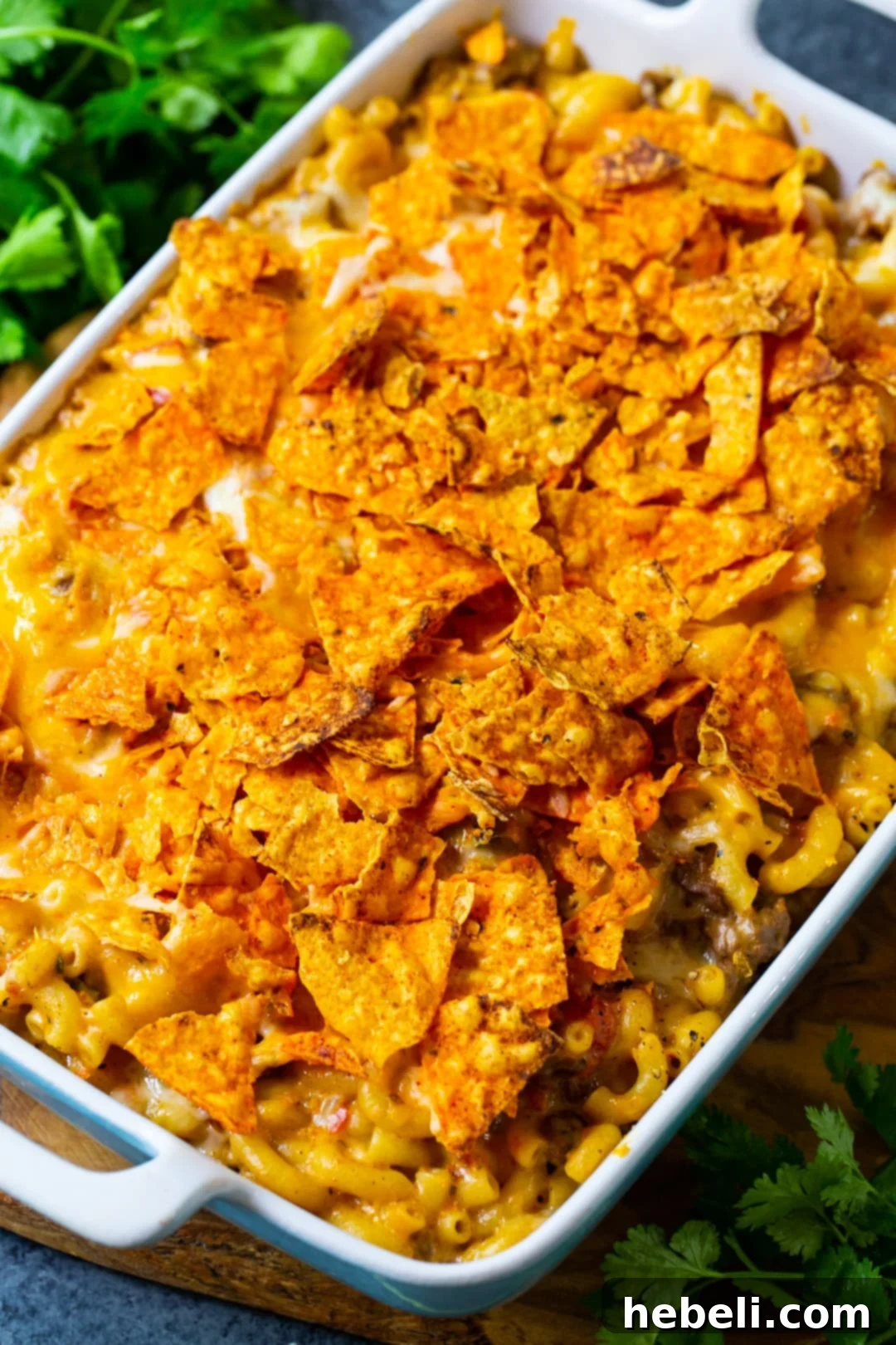 Close-up of Nacho Mac and Cheese with golden Dorito topping in a baking dish.