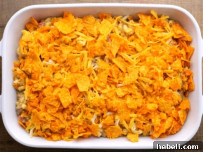 Nacho Mac and Cheese topped with cheese and crushed Doritos.